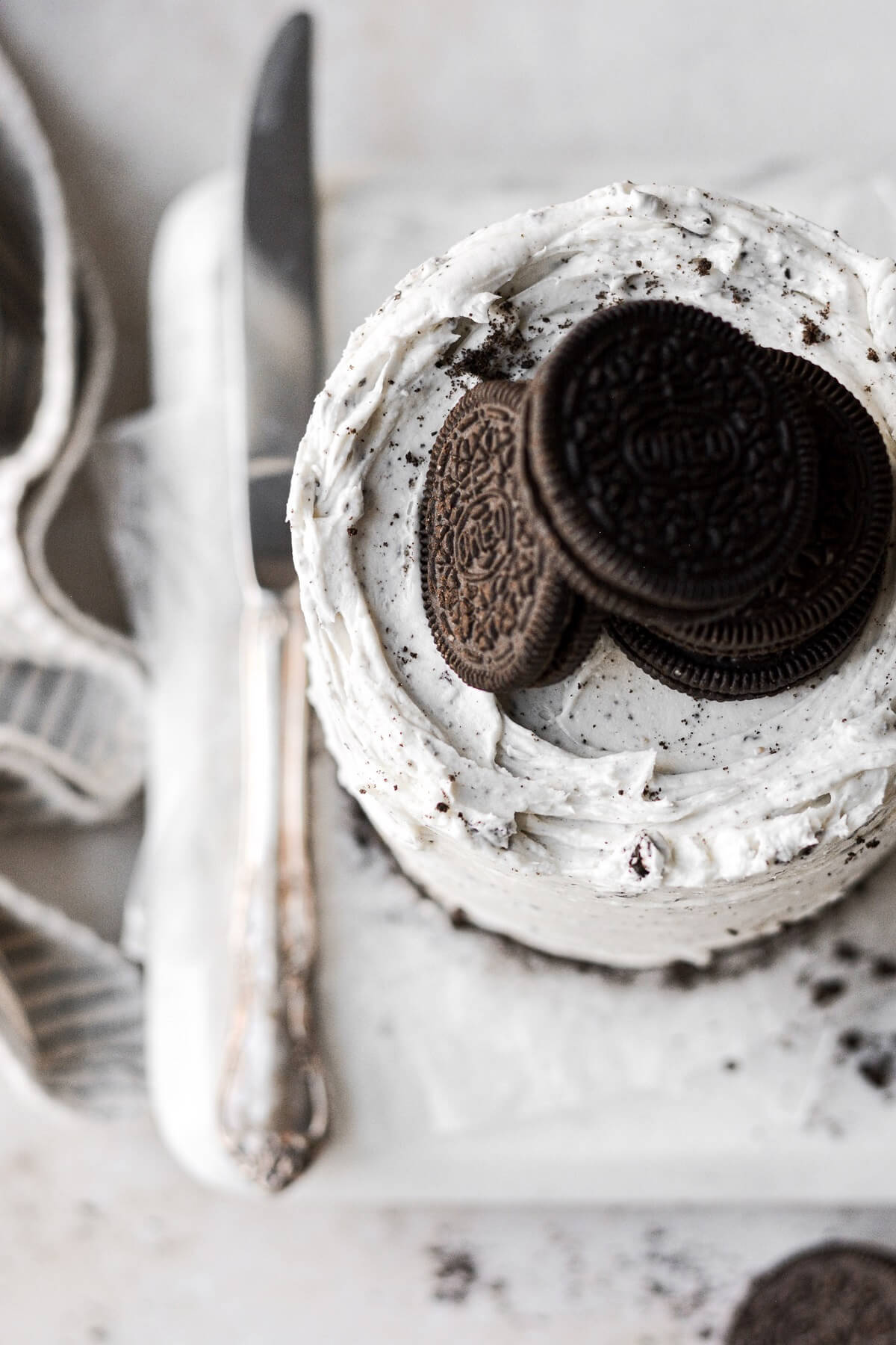 Oreos on top of cookies and cream frosting.