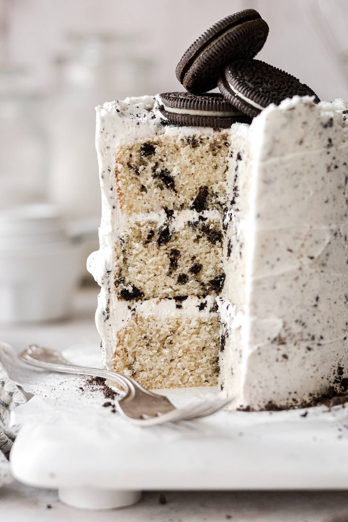Cookies and cream cake with a piece cut.