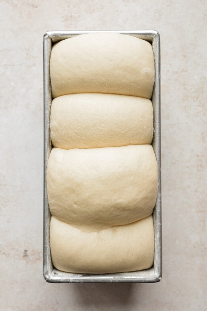 Step 14 for making a loaf of fluffy milk bread.