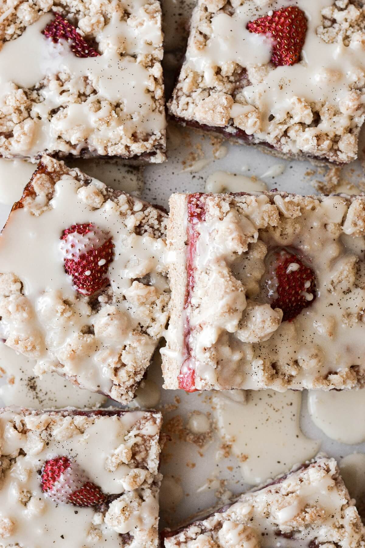 Icing drizzled over strawberry crumb bars.
