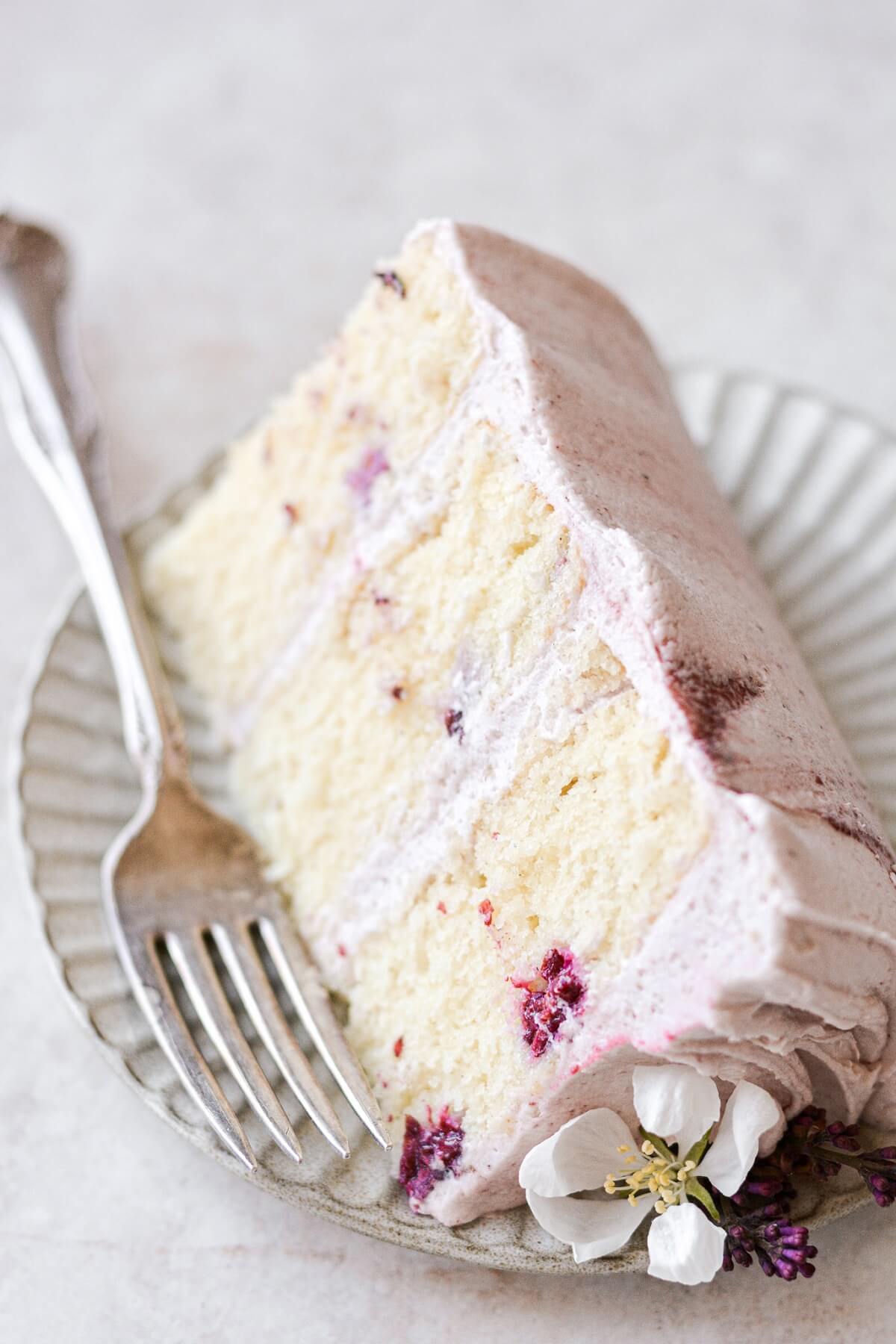 A slice of blackberry cake with a fork.