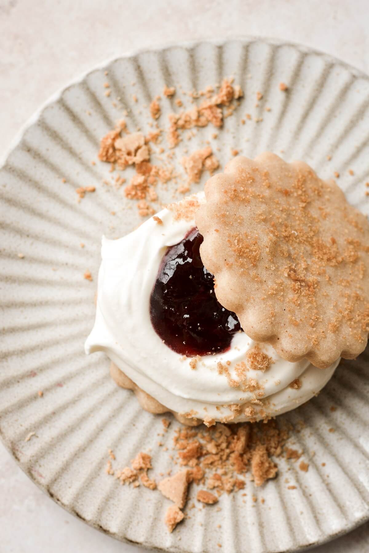 Whole wheat shortbread cookie topped with whipped cream cheese, cherry jam, and crumbled graham crackers.