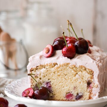 Cherry almond loaf cake with a slice cut.