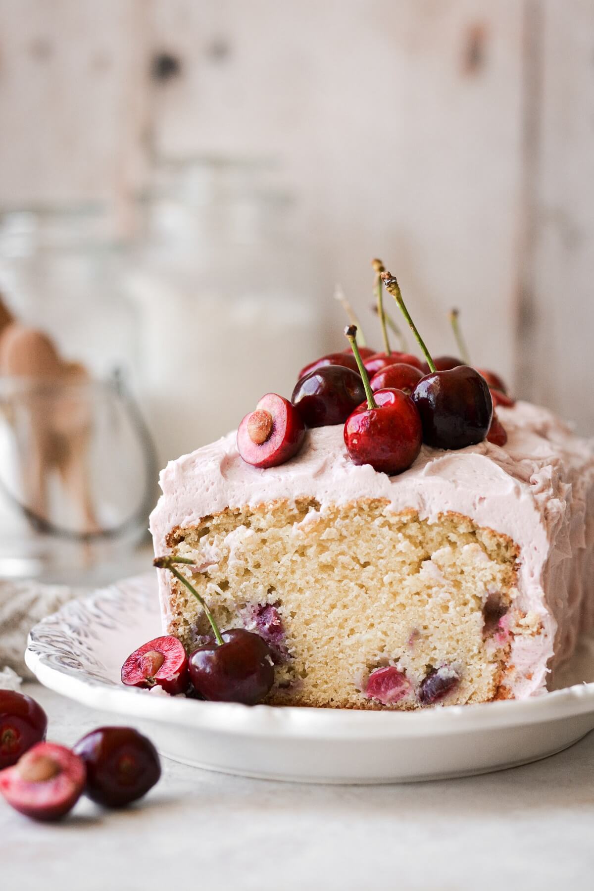 Cherry almond loaf cake with a slice cut.
