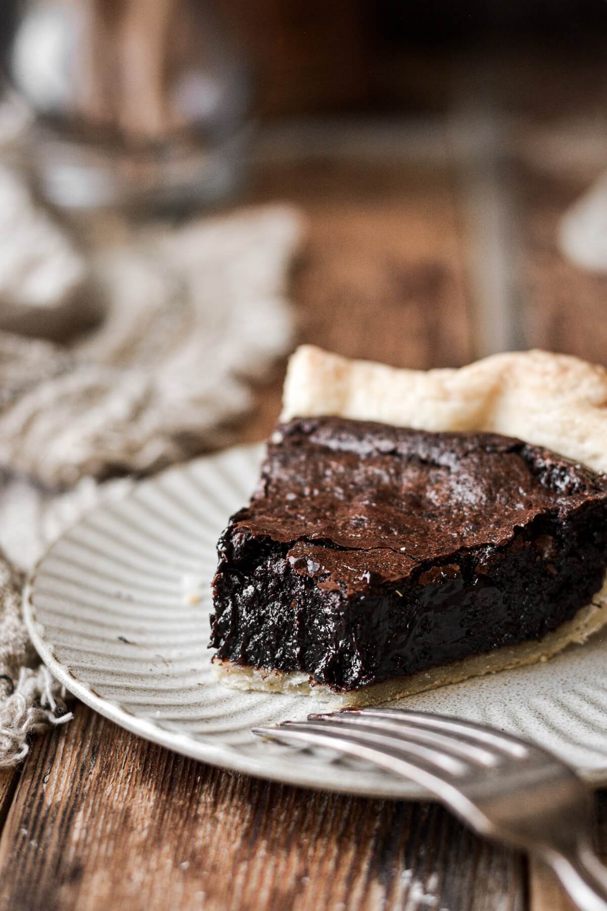 A slice of brownie pie with a bite taken.