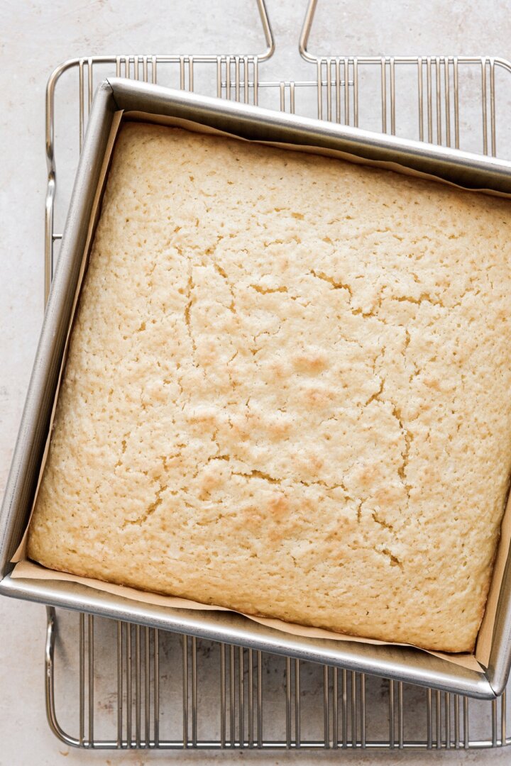 Coconut cake in a square pan.