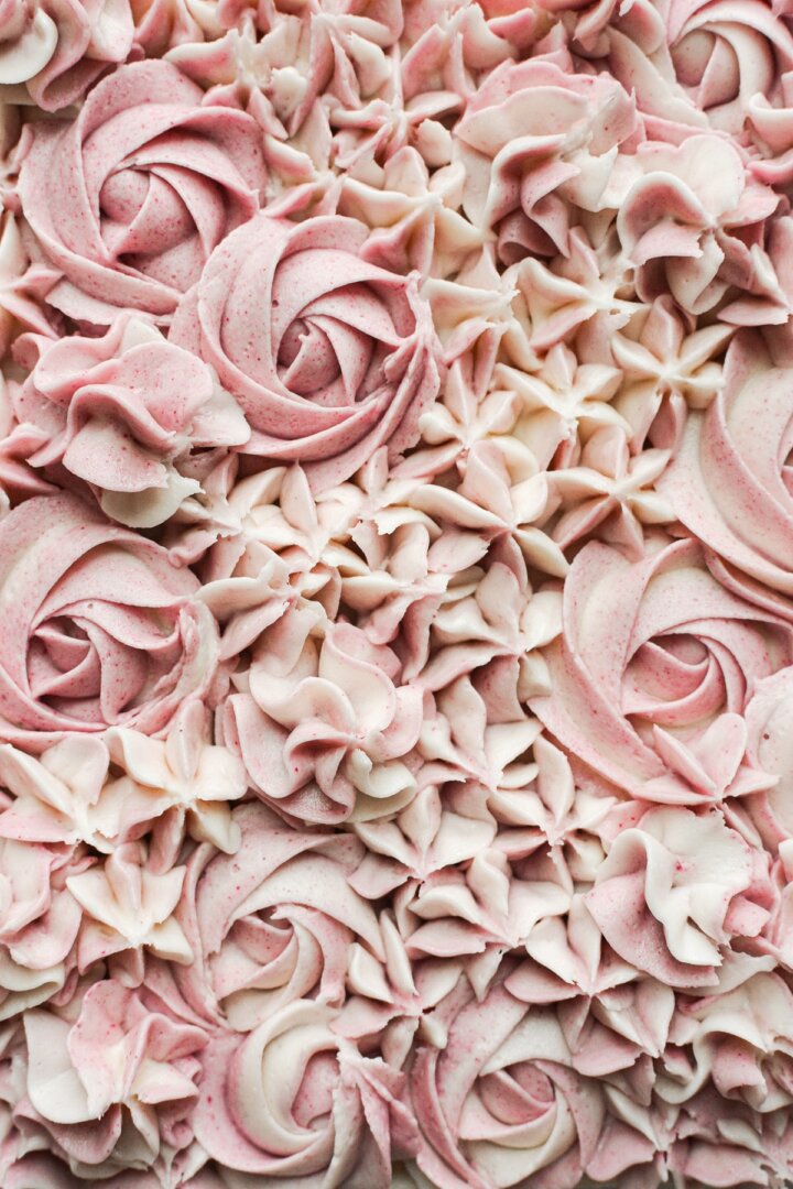 Piped buttercream flowers in shades of pink and white.