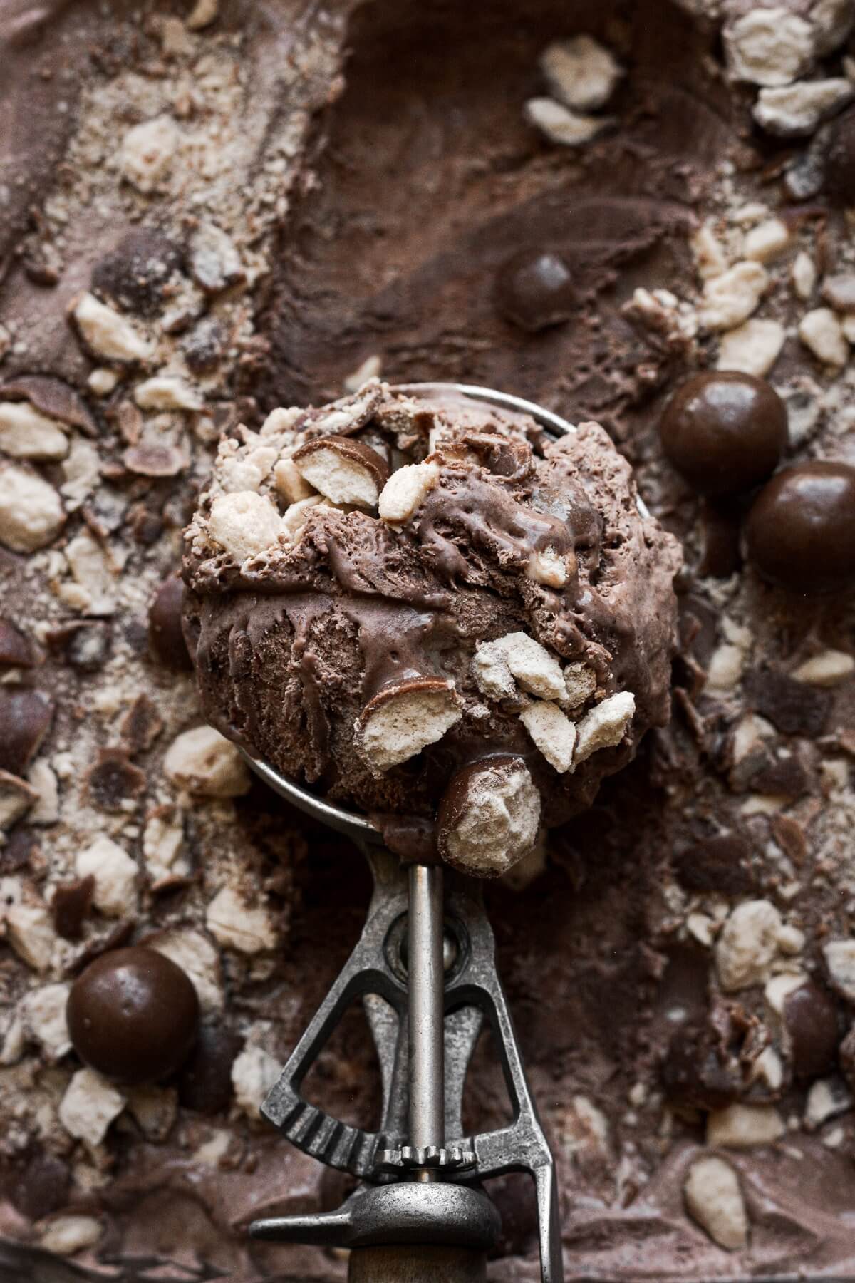 A scoop of chocolate malt ice cream with crushed Whoppers.
