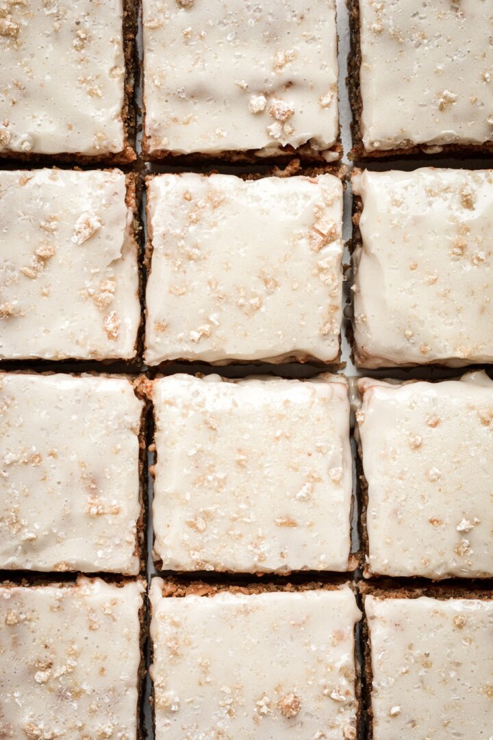 Oatmeal cream pie cookie bars with vanilla icing, cut into squares.