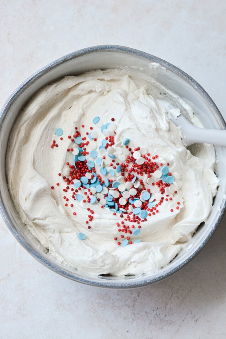 Step 5 for frosting a red, white and blue cake.