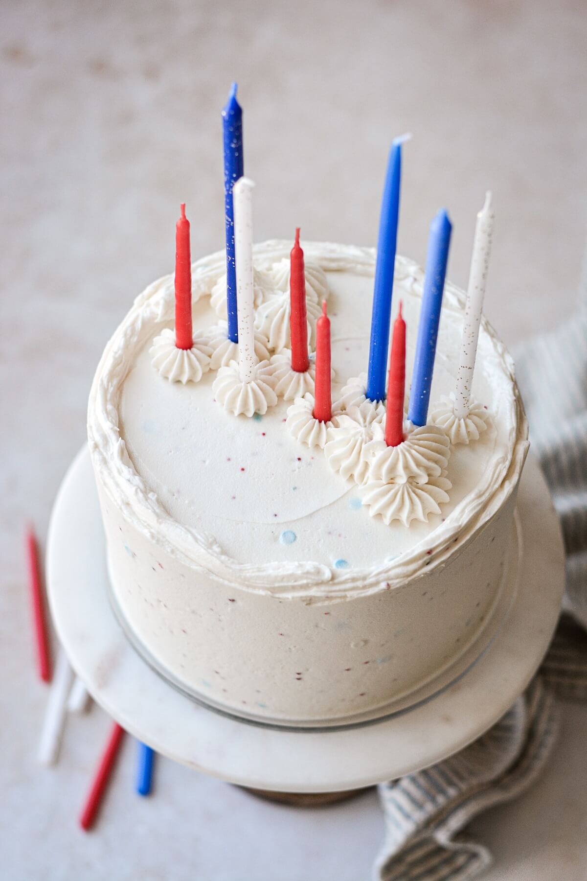 Red, white and blue candles on a cake.