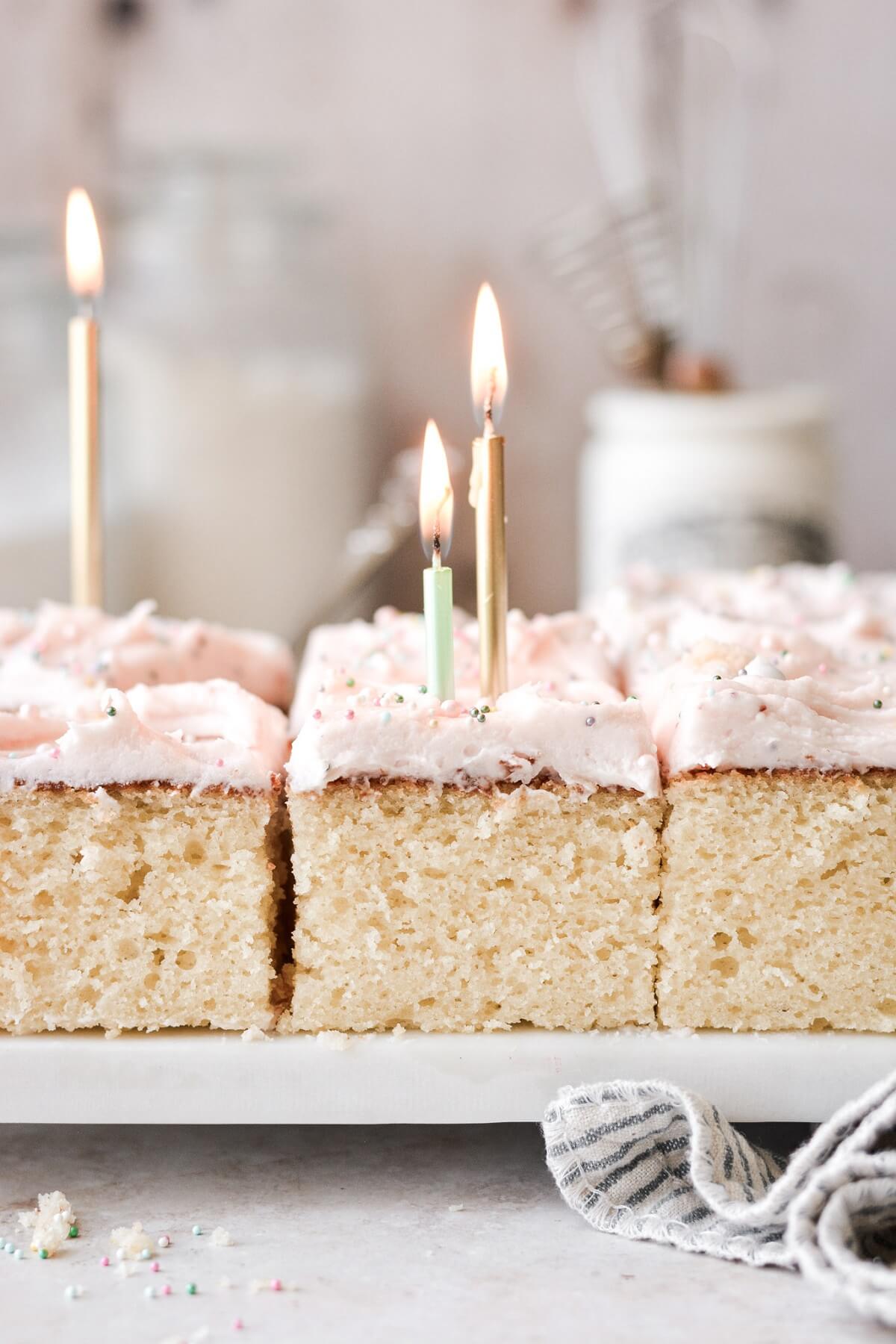 Birthday candles on top of a vanilla sheet cake.