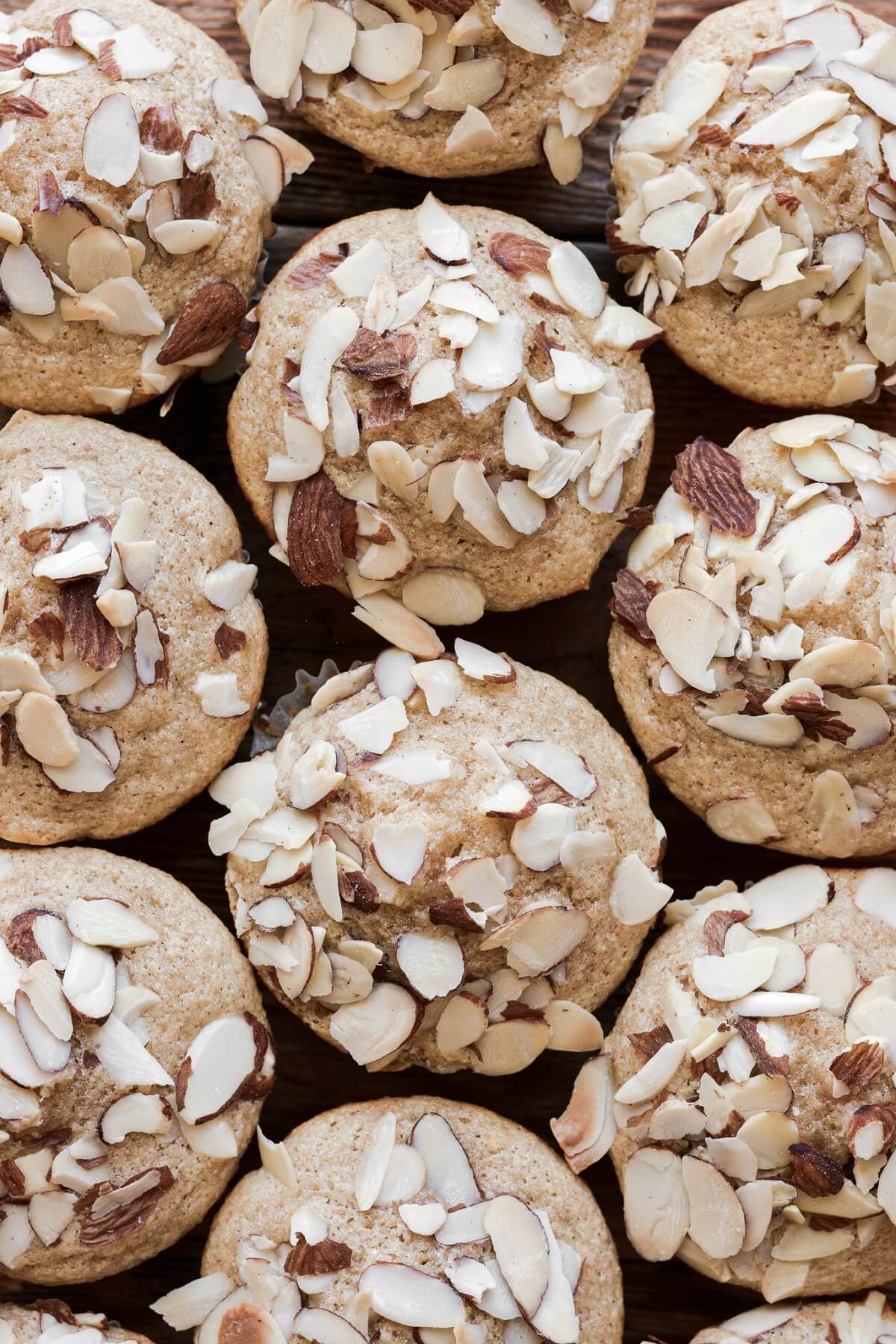 Almond muffins topped with sliced almonds.