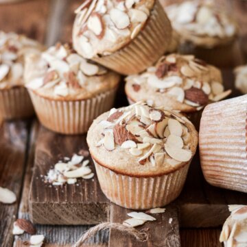Sliced almonds on top of almond muffins.