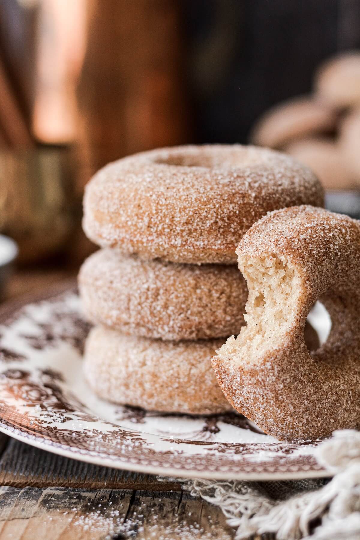 Cinnamon sugar donuts, one with a bite taken.