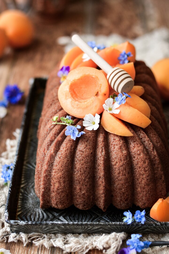 Whole wheat honey cake decorated with apricots and flowers.