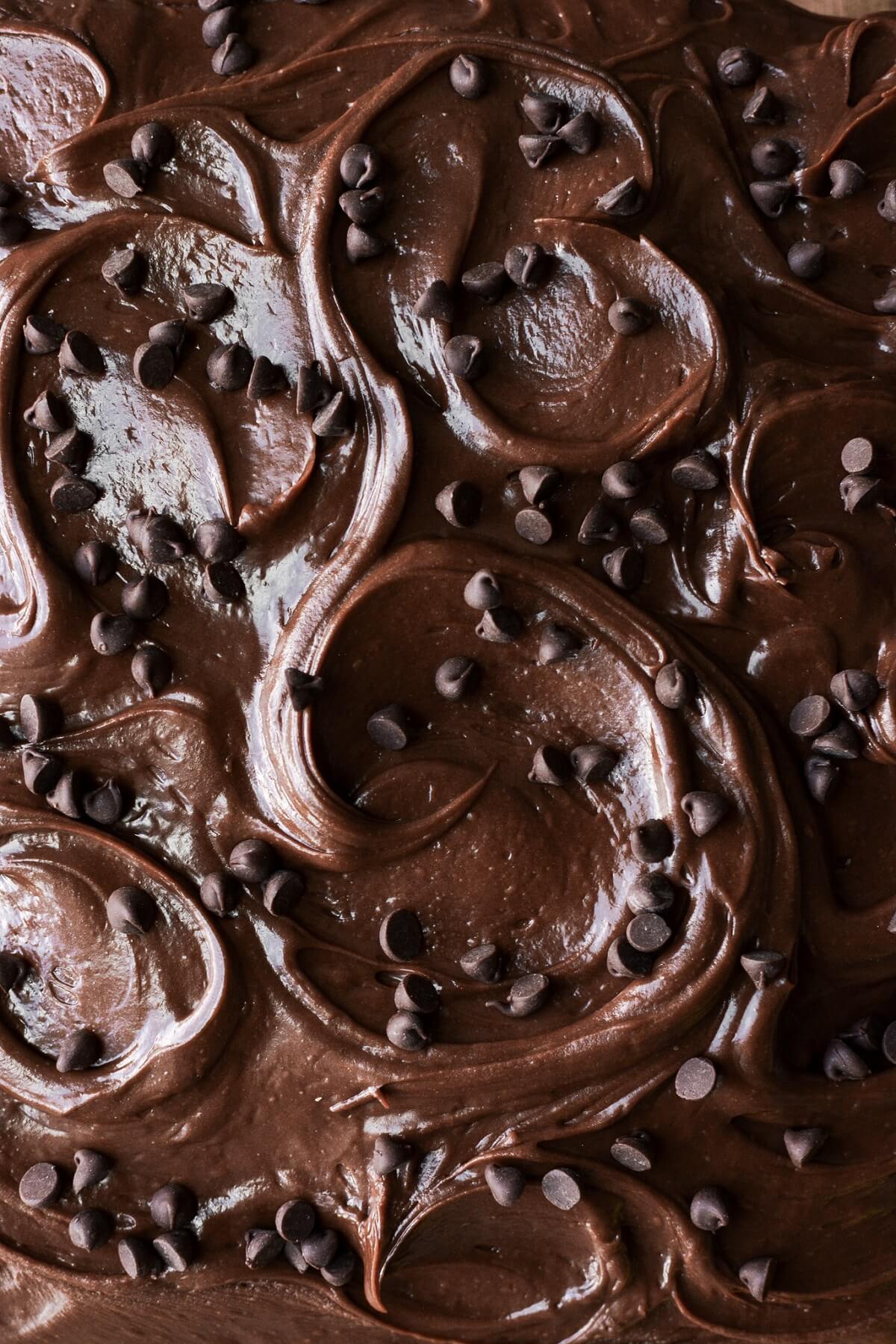 Swirls of chocolate fudge frosting with chocolate chips.
