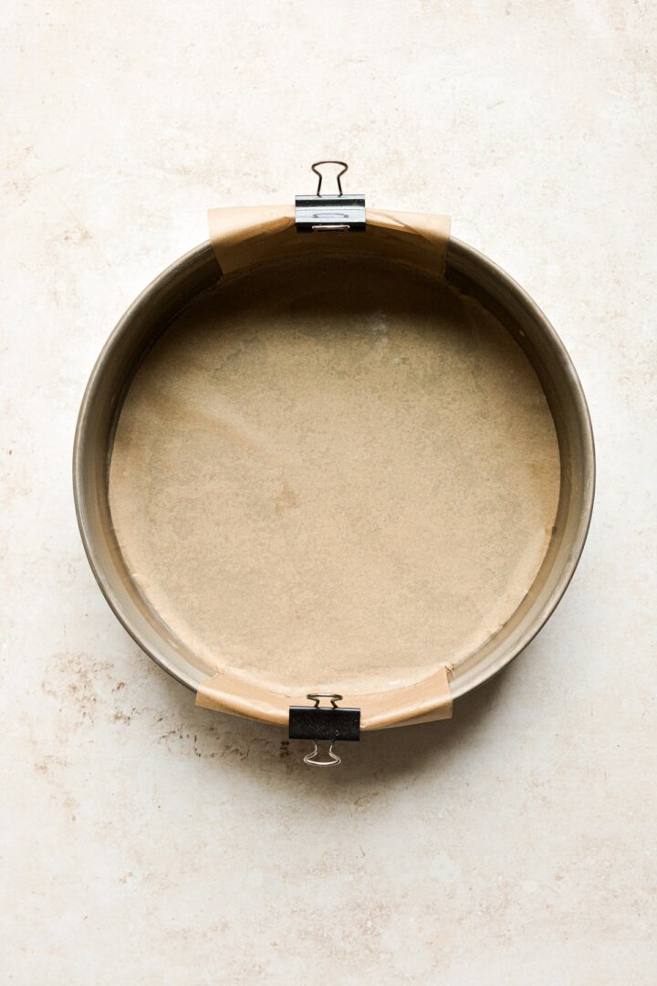 A cake pan lined with parchment paper.