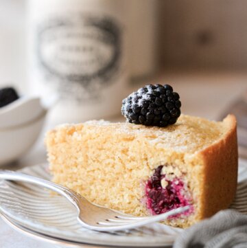 A slice of blackberry cornbread cake on a plate.