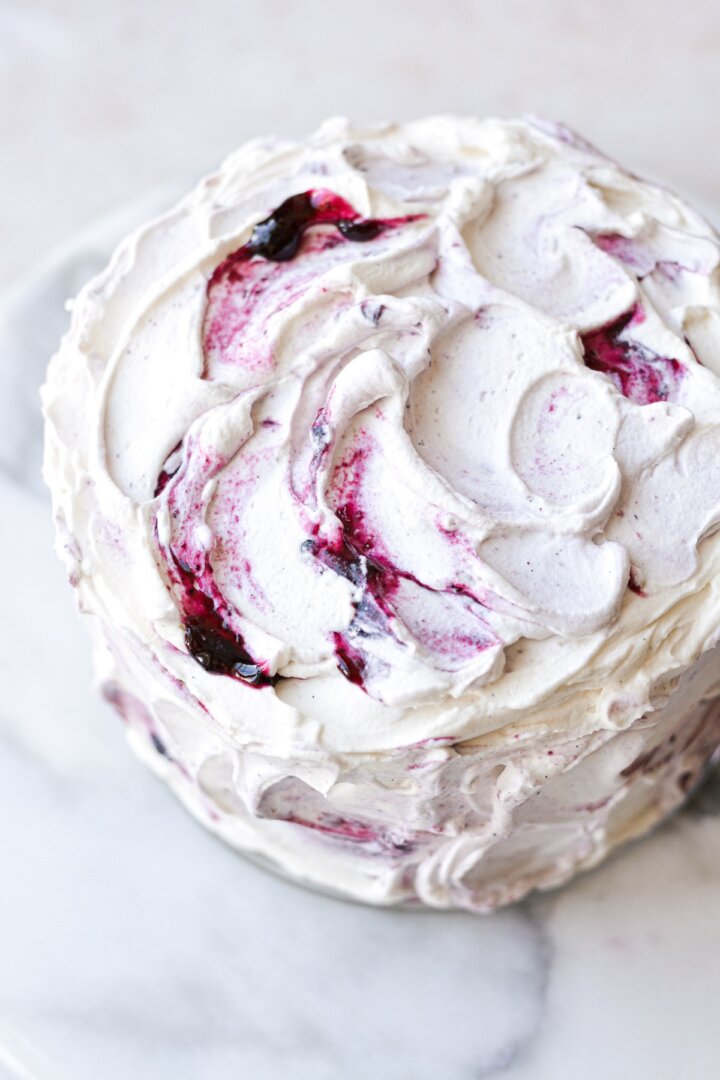 Whipped cream frosting swirled with blueberry jam.