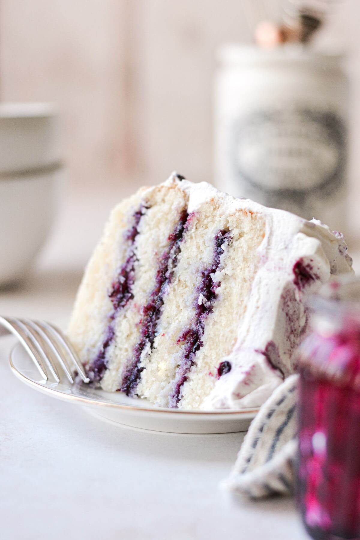 A slice of blueberry jam and cream chantilly cake.