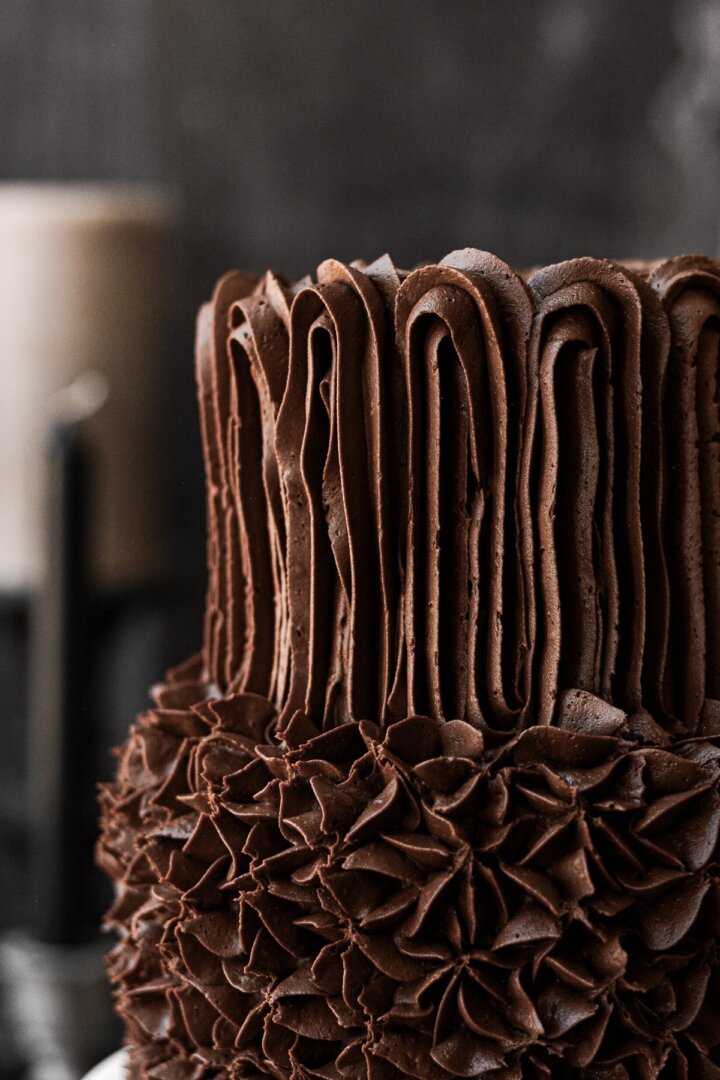 Chocolate buttercream piped on a cake.