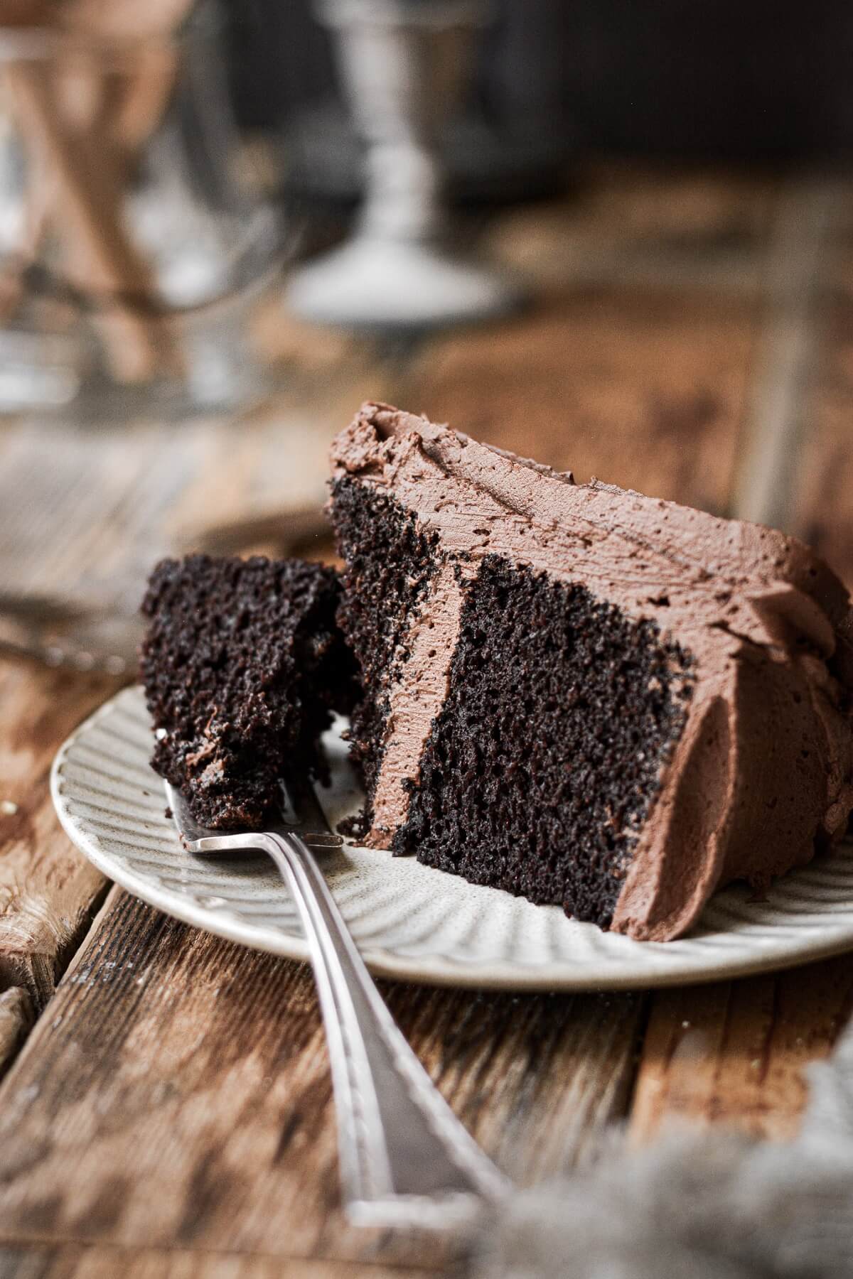 Slice of chocolate cake with a bite taken.