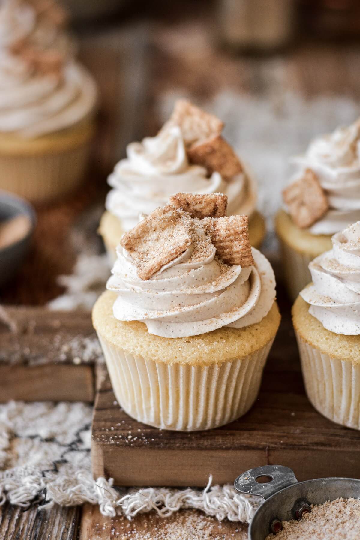 Cinnamon toast crunch cereal on top of cupcakes.