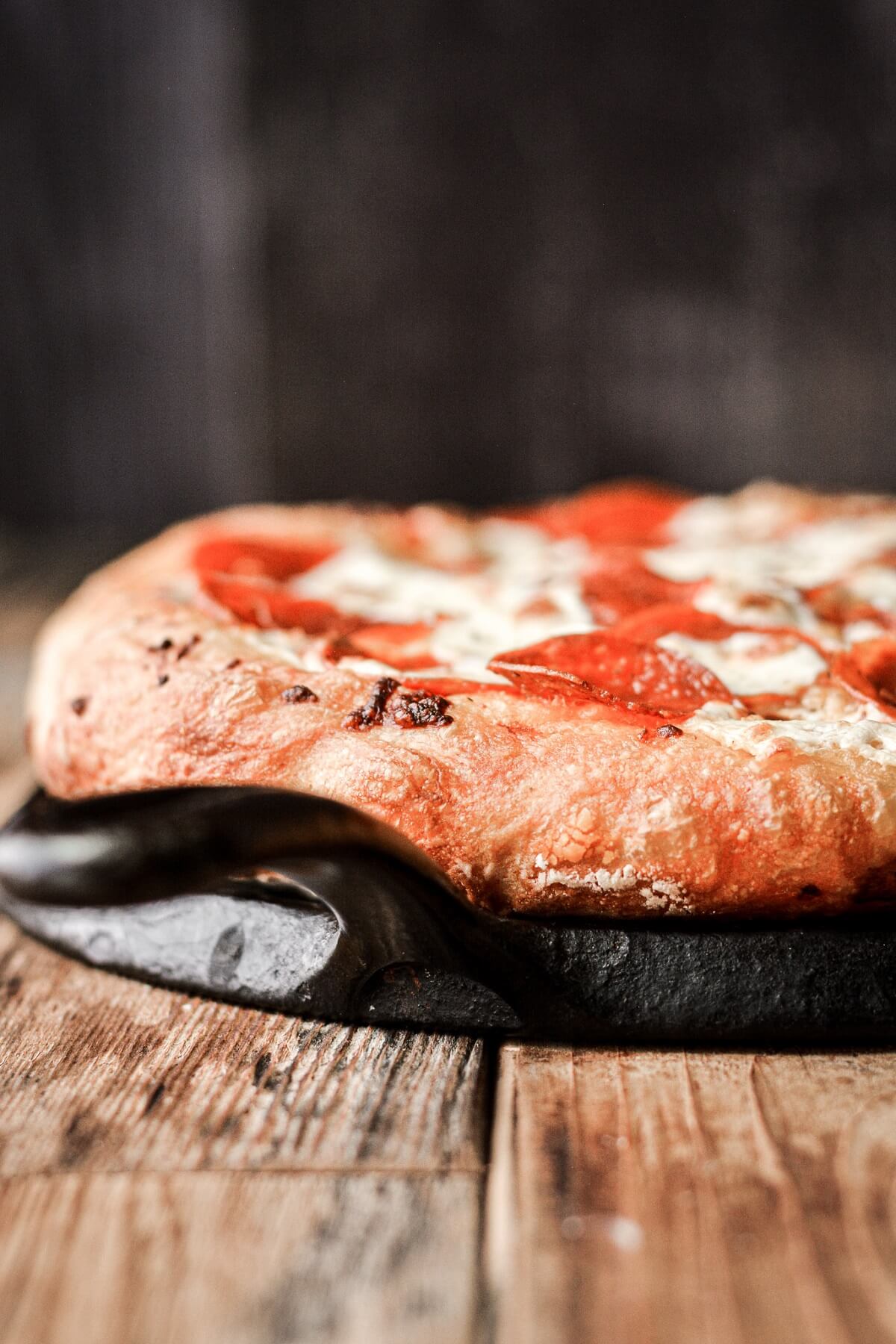 Pepperoni pizza baked in a cast iron pan.