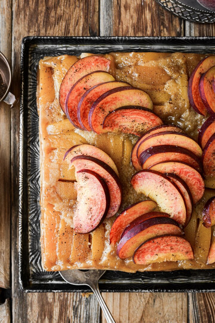 Peach upside down cake topped with fresh sliced peaches.