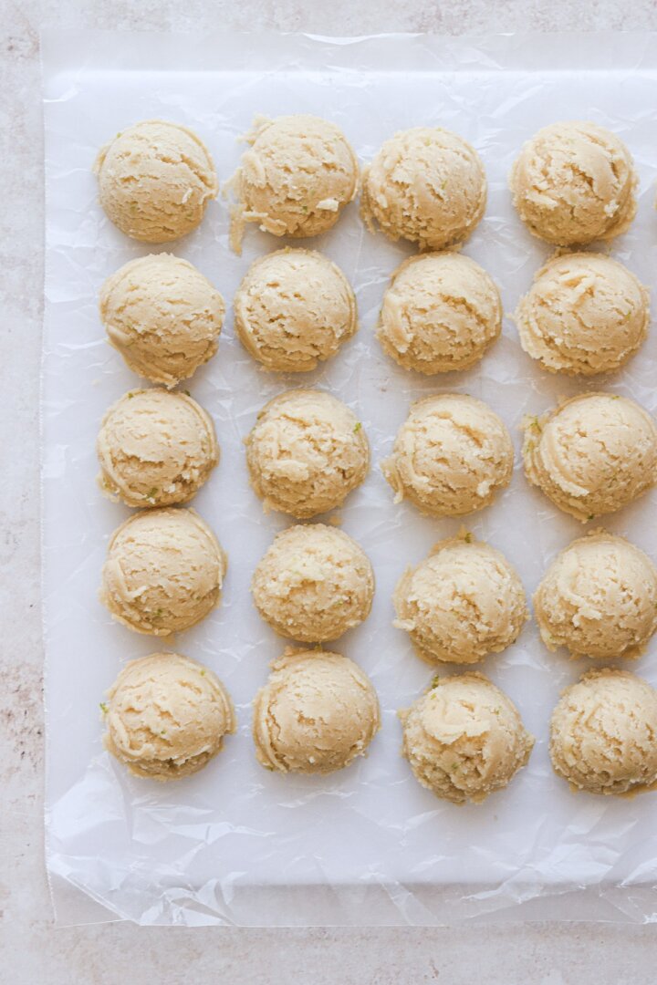 Lime sugar cookie dough scooped into balls.