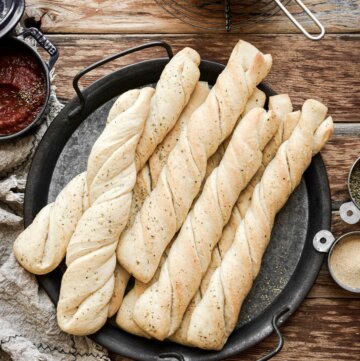 Homemade breadsticks with marinara dipping sauce.