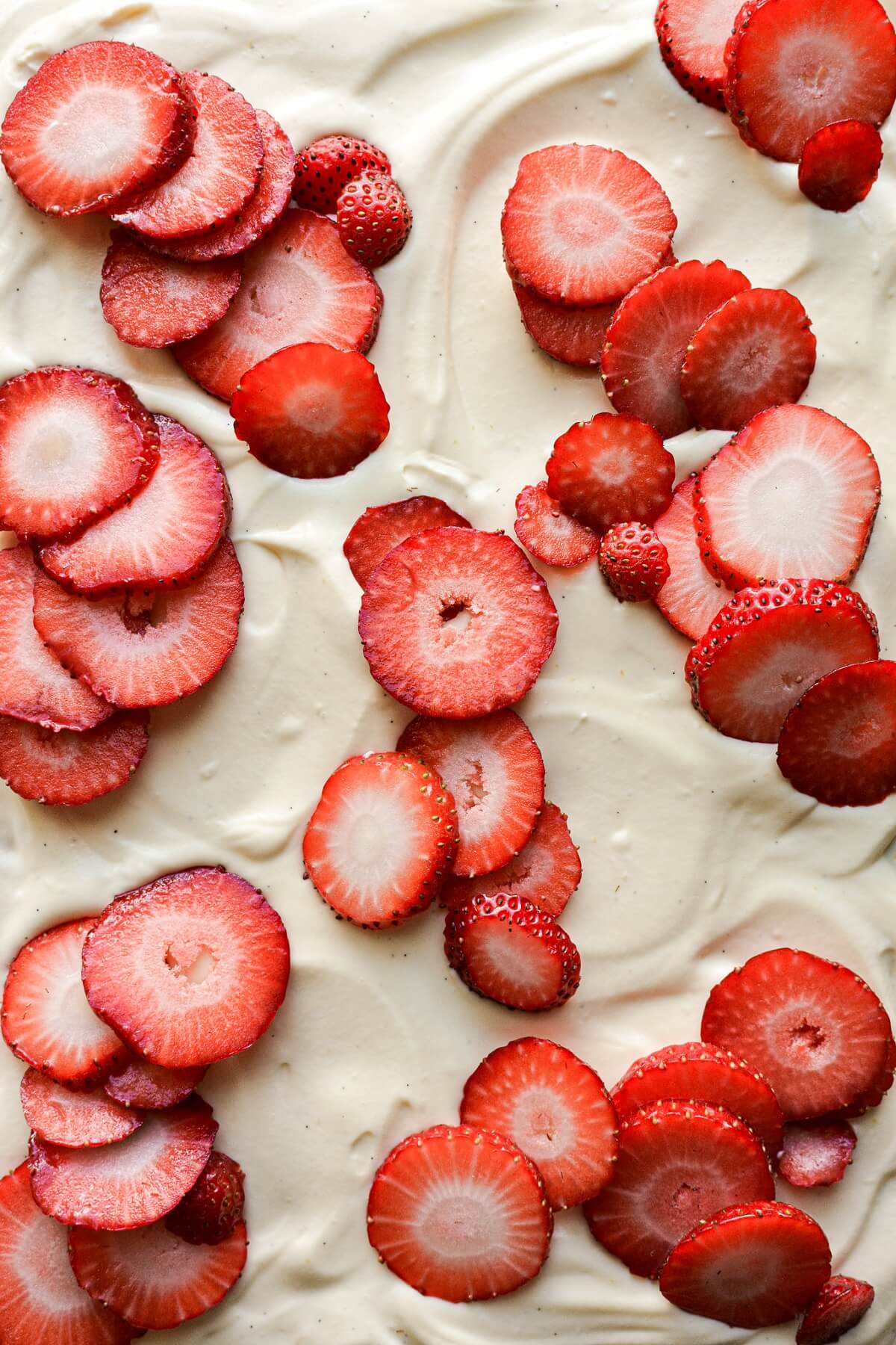 Sliced strawberries on mascarpone cream.