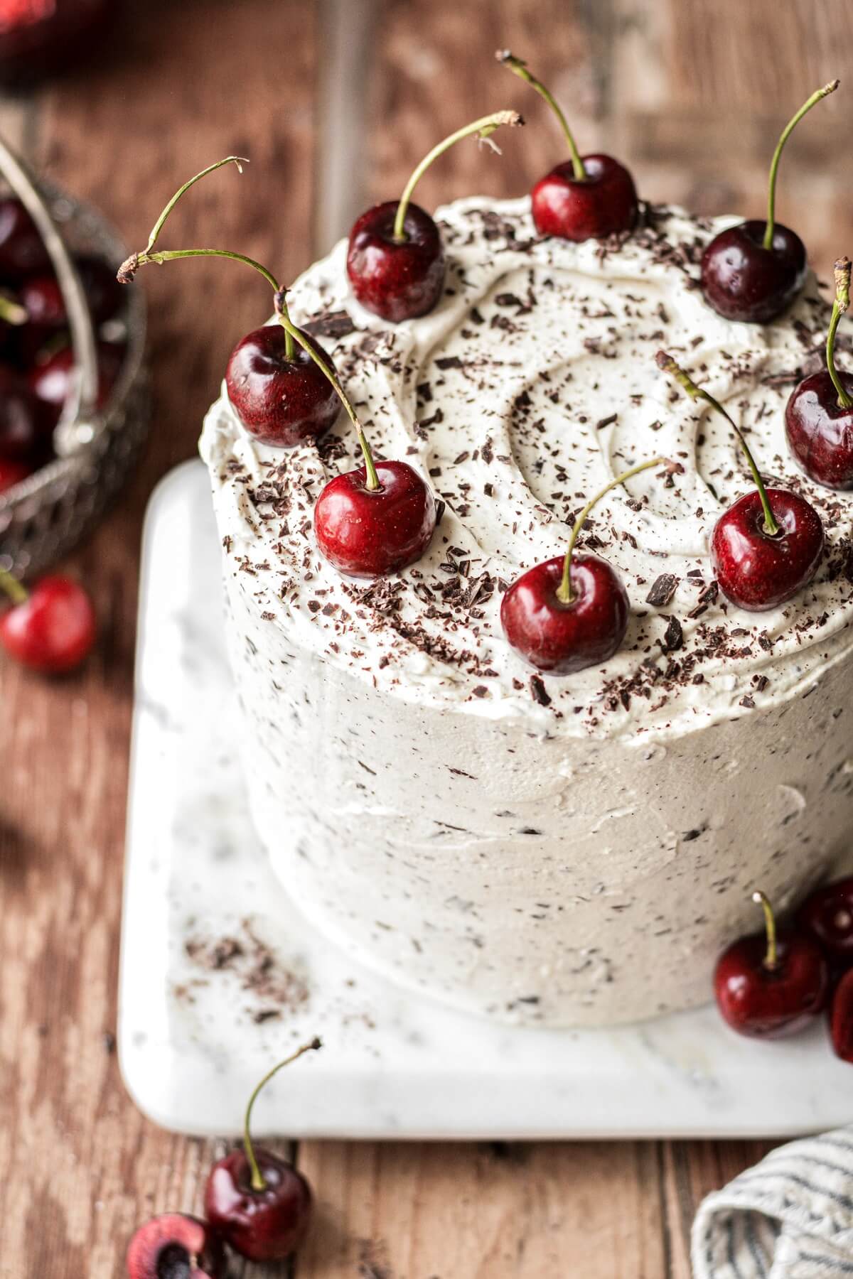 Cherries on top of a white forest cake.