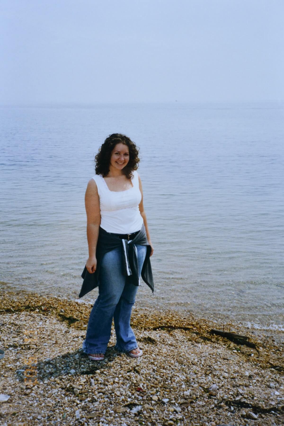 A girl standing on a beach.