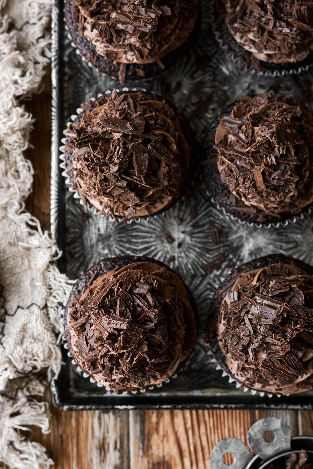 Chocolate espresso cupcakes with chocolate shavings.