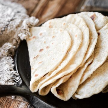 Homemade flour tortillas folded in half.