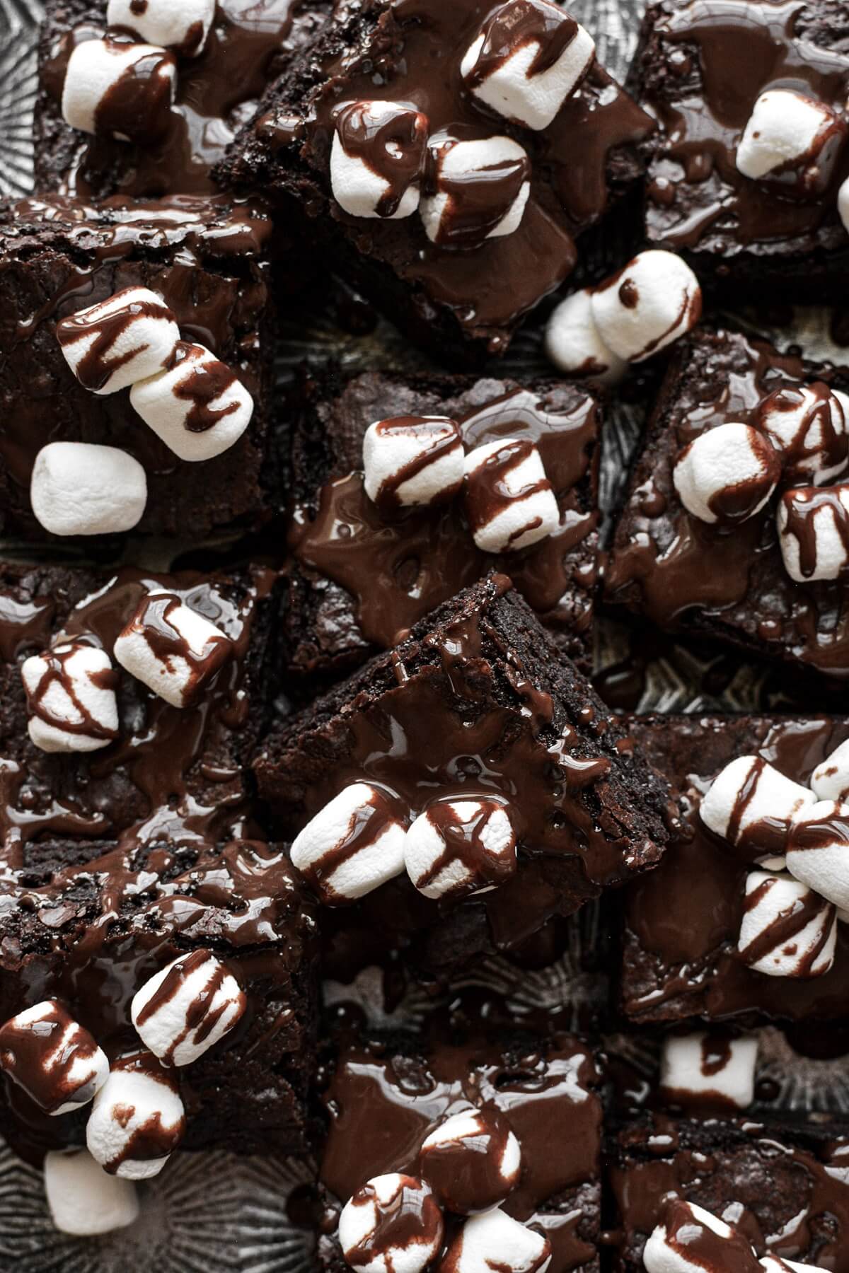 Hot chocolate fudge brownies, sprinkled with mini marshmallows and drizzled with chocolate ganache.