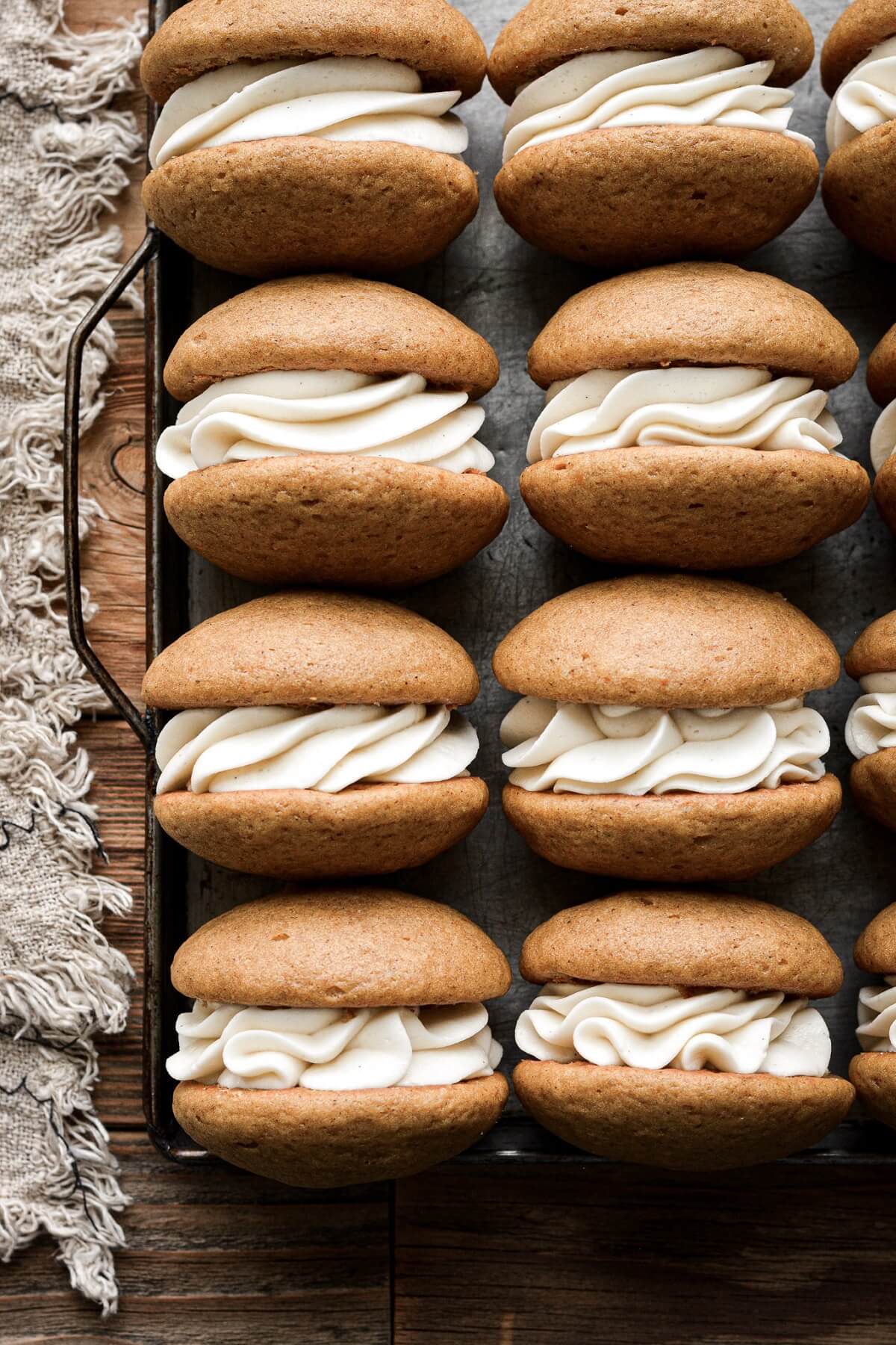 Pumpkin whoopie pies filled with cream cheese buttercream.