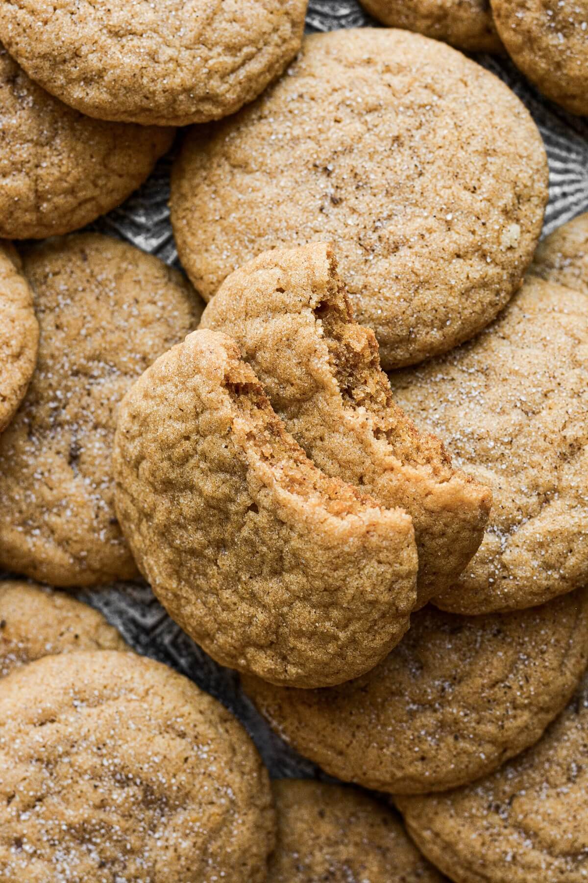 Chewy pumpkin cookies with a bite taken.