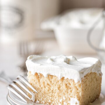 A piece of tres leches cake on a plate.