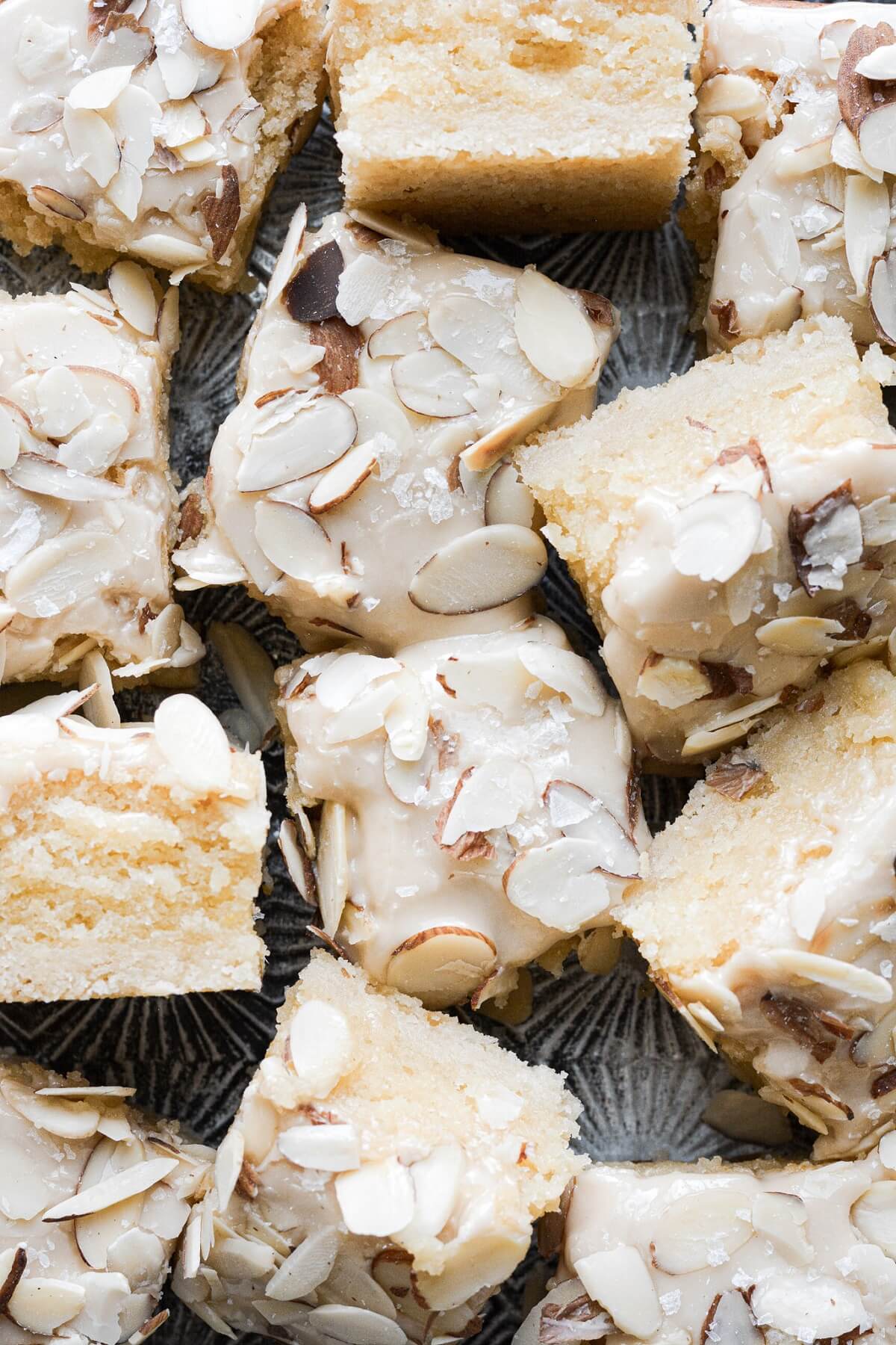 Almond amaretto bars with amaretto icing and sliced almonds on top.