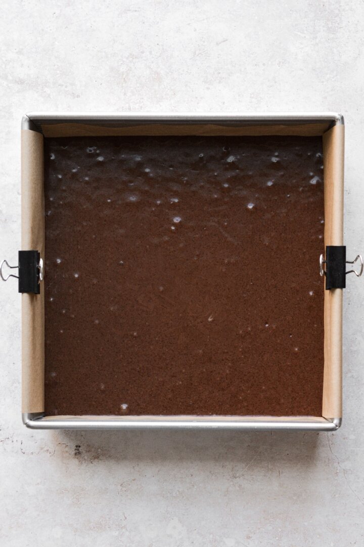 Chocolate cake batter in a baking pan.