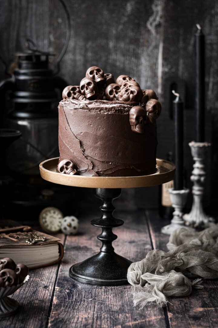 Chocolate skull cake on a bronze and black cake stand.