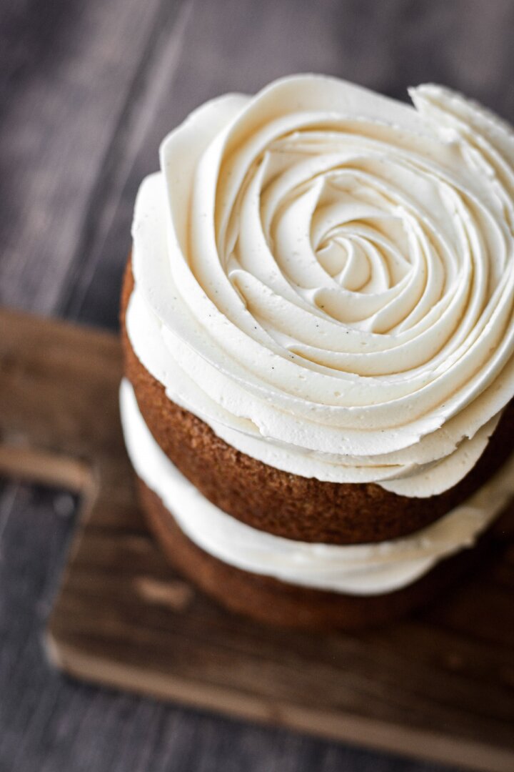 Swirl of vanilla buttercream on pumpkin cake.