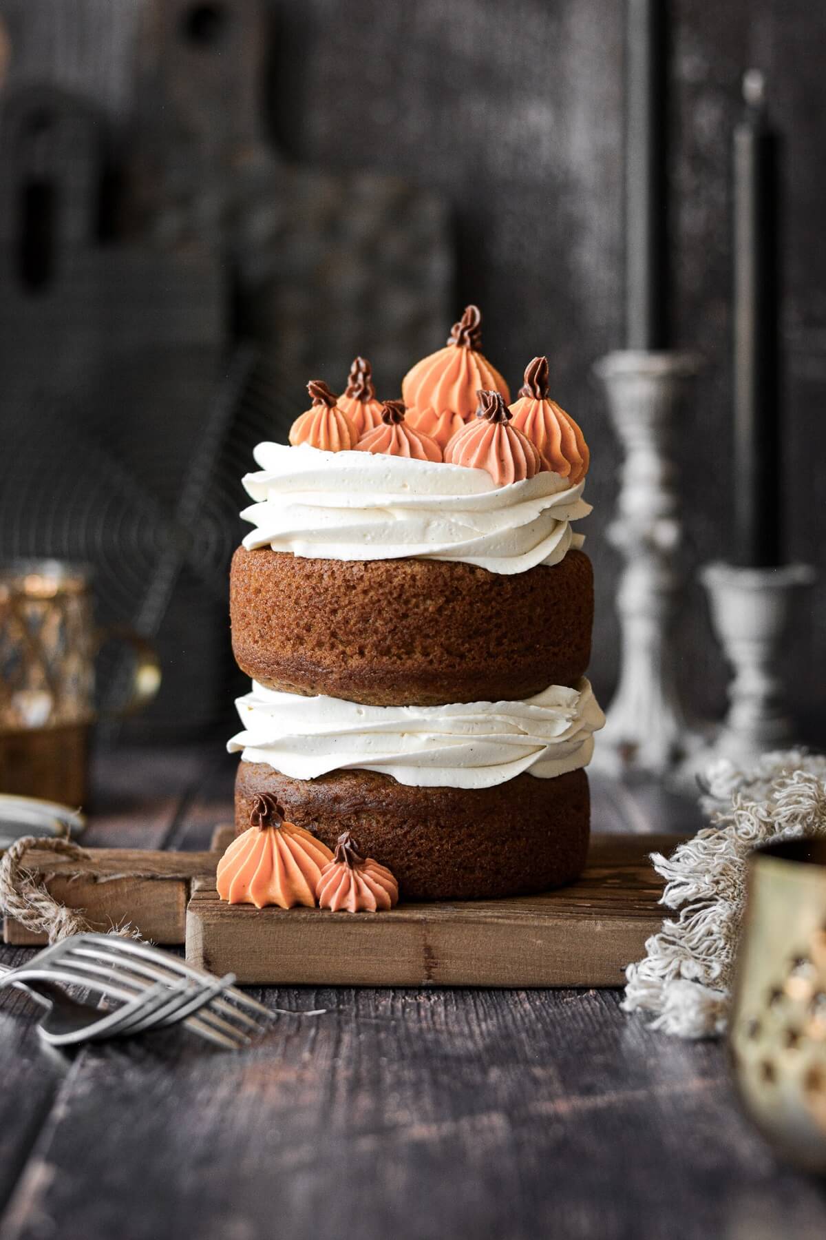 A mini naked pumpkin layer cake with buttercream pumpkins.