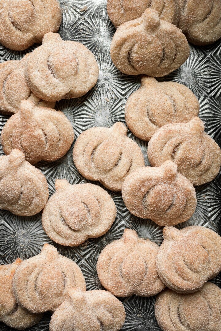 Mini pumpkin shaped pies coated in cinnamon sugar.