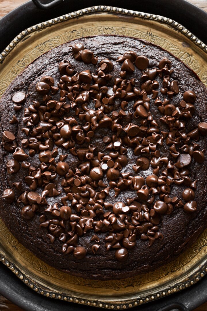Chocolate chips sprinkled on top of a chocolate ricotta cake.