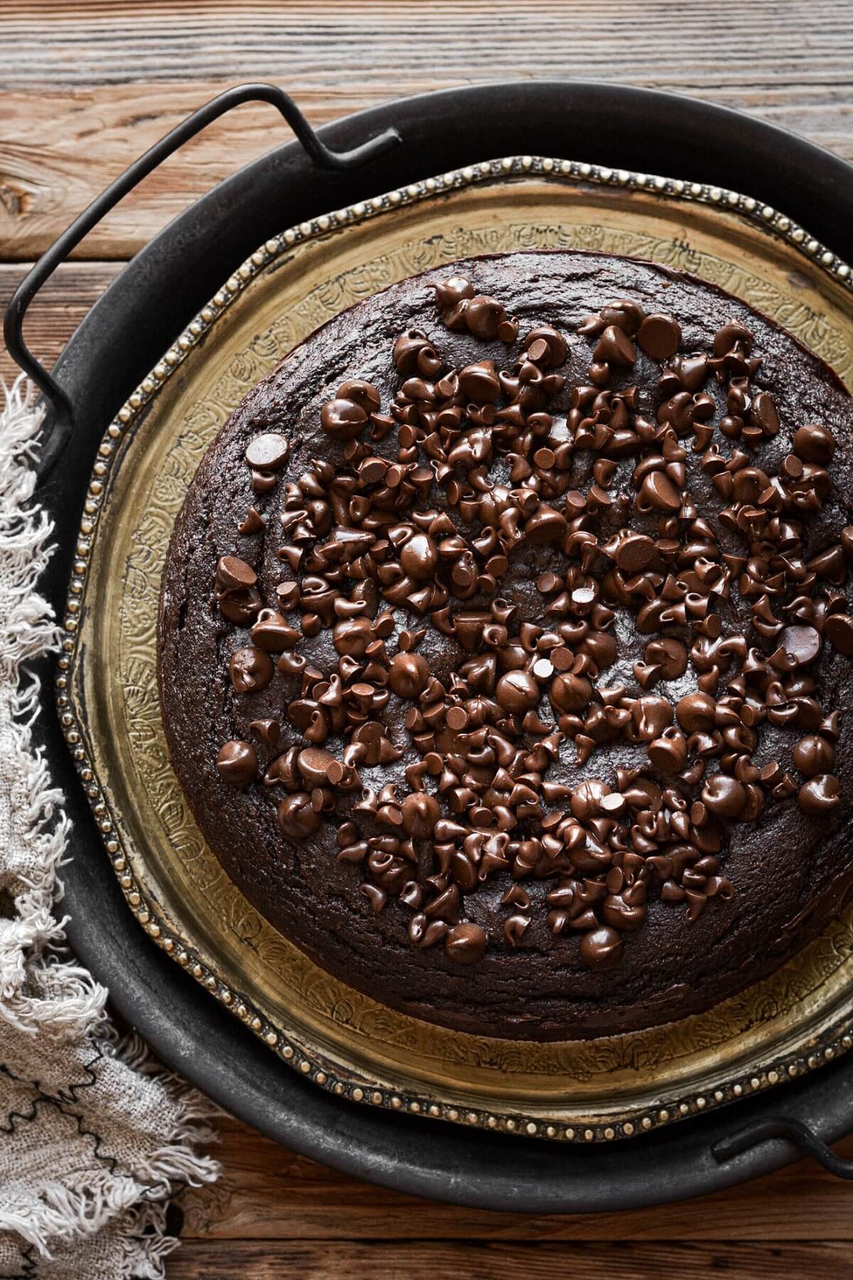 One layer chocolate ricotta cake sprinkled with chocolate chips.
