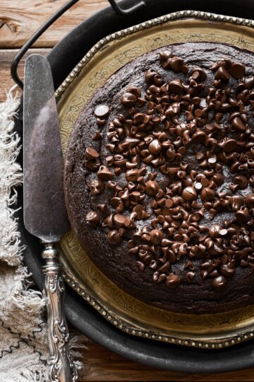 Chocolate ricotta cake with chocolate chips on a vintage plate.